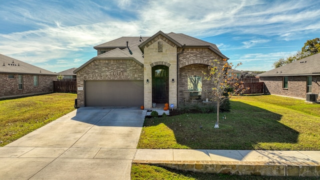 french country inspired facade featuring a front lawn, central AC unit, and a garage