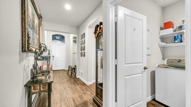 hallway featuring washer / clothes dryer and hardwood / wood-style floors