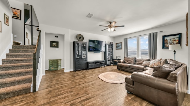 living room with hardwood / wood-style flooring and ceiling fan