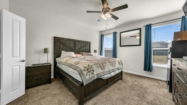 carpeted bedroom featuring ceiling fan and multiple windows