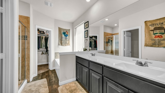 bathroom with shower with separate bathtub, vanity, and hardwood / wood-style flooring