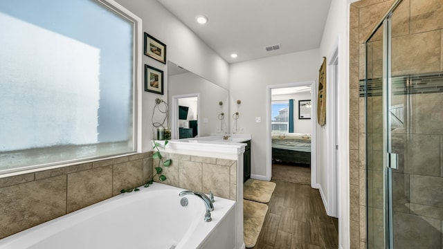 bathroom featuring hardwood / wood-style floors, vanity, shower with separate bathtub, and a wealth of natural light