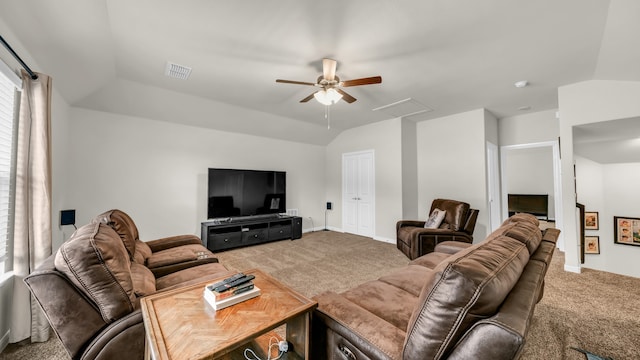 carpeted living room with ceiling fan and vaulted ceiling