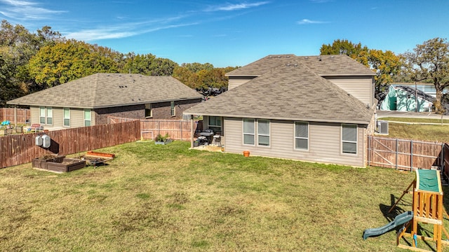 rear view of property with a yard