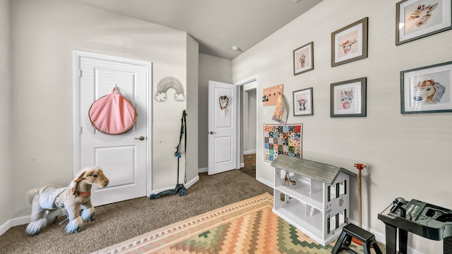 foyer entrance featuring dark carpet