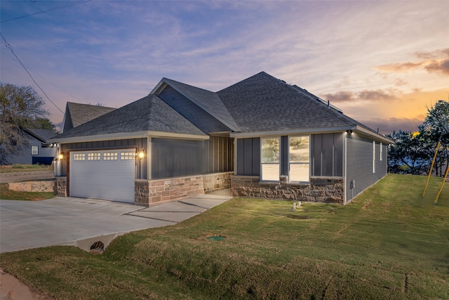 view of front of property with a yard and a garage