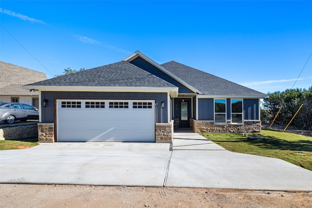 craftsman-style house featuring a front yard and a garage