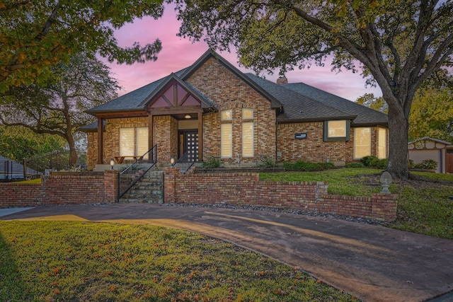 tudor home with a yard