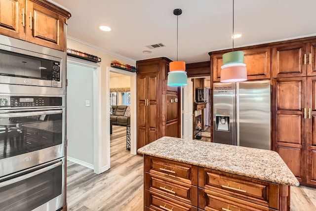 kitchen with crown molding, light hardwood / wood-style flooring, appliances with stainless steel finishes, decorative light fixtures, and light stone counters