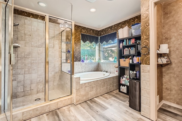 bathroom with plus walk in shower, wood-type flooring, and ornamental molding