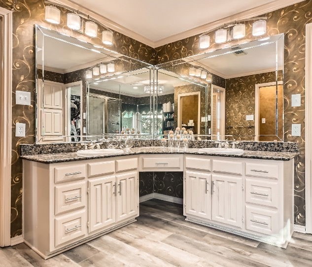 bathroom featuring vanity, wood-type flooring, and ornamental molding