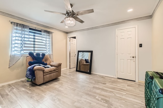 living area featuring ceiling fan, light hardwood / wood-style floors, and ornamental molding