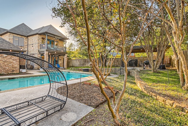 pool at dusk with a patio