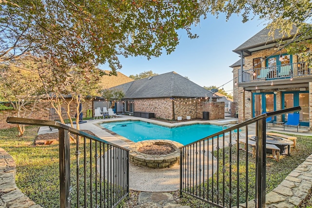 view of pool with a diving board and a patio