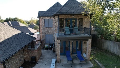 back of house featuring french doors, a patio, and a balcony