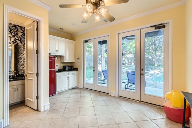 doorway to outside with ceiling fan, french doors, light tile patterned flooring, and ornamental molding