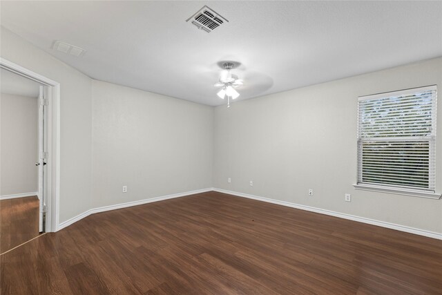 empty room with ceiling fan and dark hardwood / wood-style floors