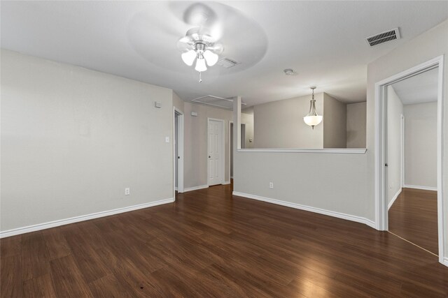 unfurnished room featuring dark hardwood / wood-style floors and ceiling fan