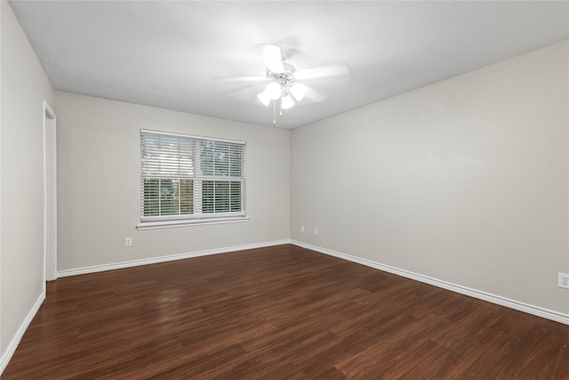 empty room with dark hardwood / wood-style floors and ceiling fan