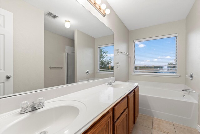 bathroom featuring tile patterned floors, vanity, and shower with separate bathtub