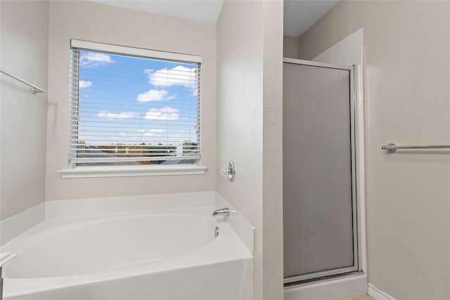 bathroom featuring separate shower and tub