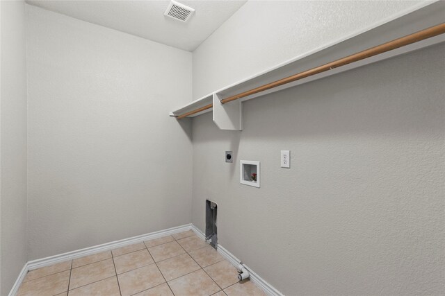 clothes washing area featuring washer hookup, light tile patterned flooring, and hookup for an electric dryer