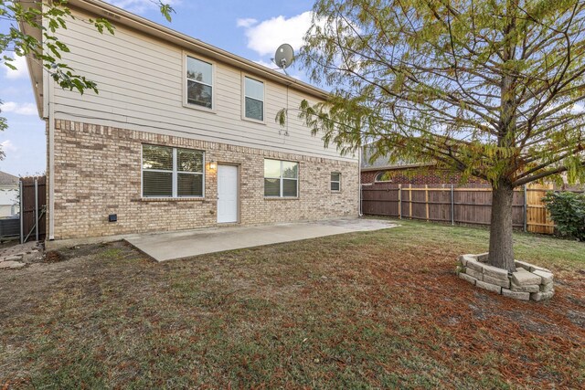 rear view of property with a patio area and a yard