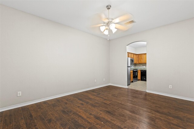 spare room with ceiling fan and wood-type flooring