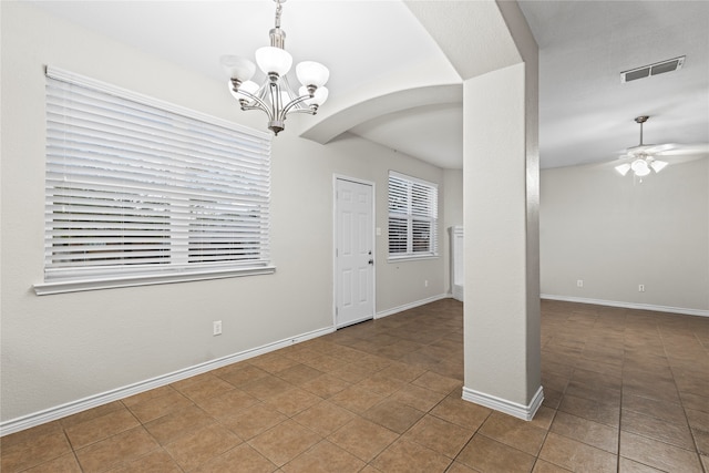 unfurnished room with ceiling fan with notable chandelier and tile patterned floors