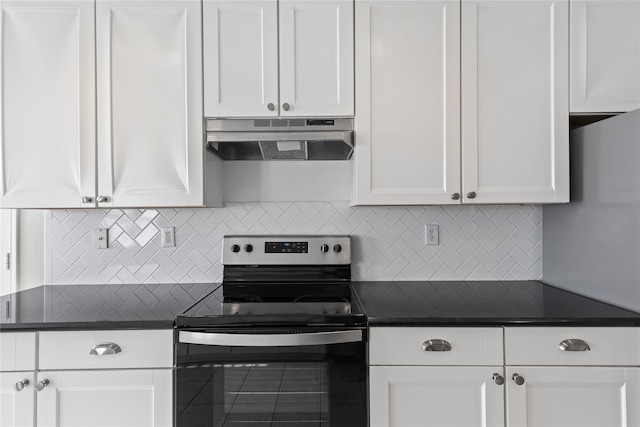 kitchen featuring stainless steel electric stove, white cabinetry, and tasteful backsplash