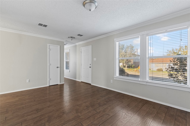 empty room with ornamental molding, a textured ceiling, and dark wood-type flooring