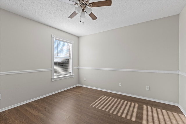 spare room with ceiling fan, dark hardwood / wood-style flooring, and a textured ceiling