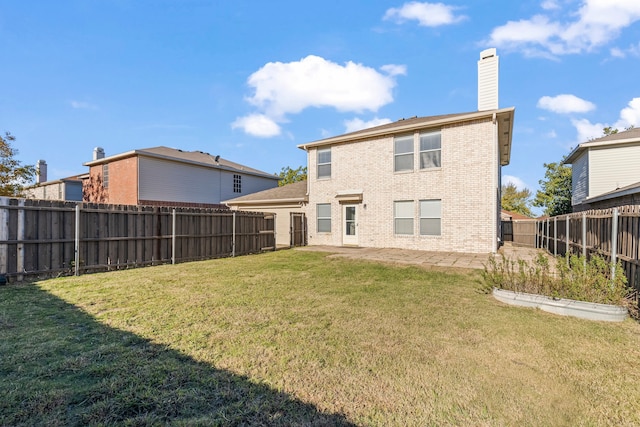 back of house with a lawn