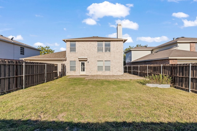 rear view of house featuring a patio area and a yard