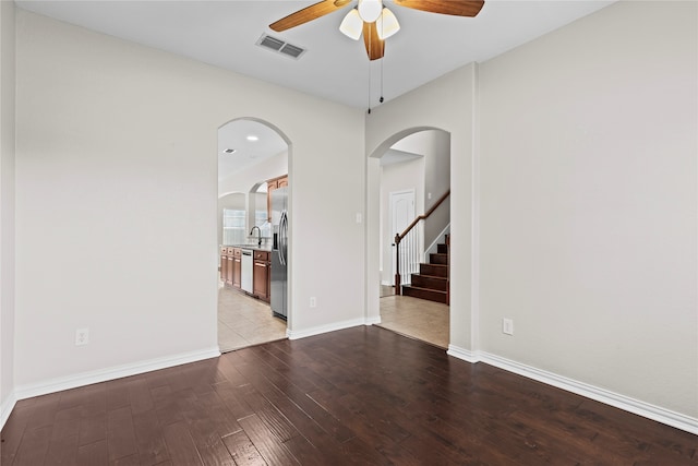 unfurnished room featuring light hardwood / wood-style floors, ceiling fan, and sink