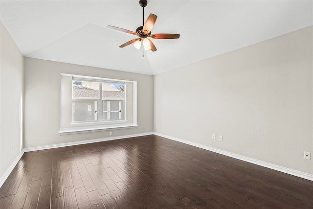 spare room with ceiling fan, lofted ceiling, and dark wood-type flooring