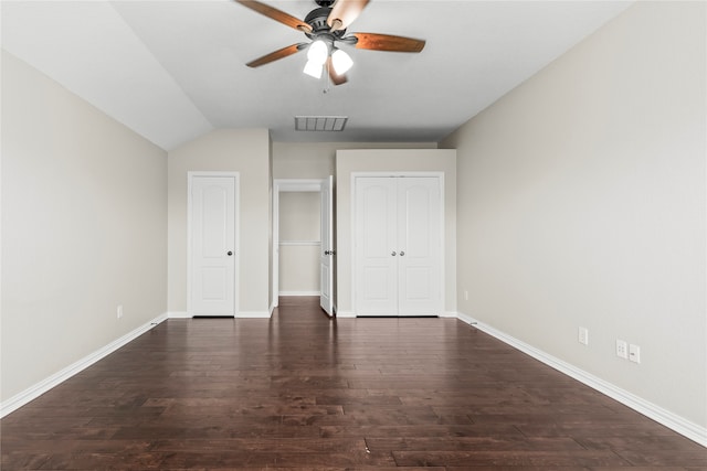 unfurnished bedroom with lofted ceiling, ceiling fan, and dark hardwood / wood-style floors