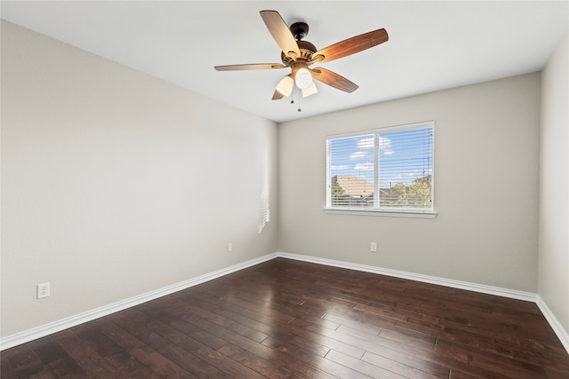 spare room with ceiling fan and dark hardwood / wood-style flooring