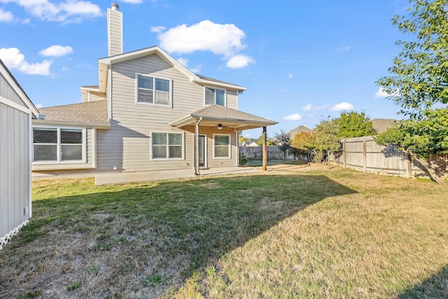 back of property featuring ceiling fan, a yard, and a patio