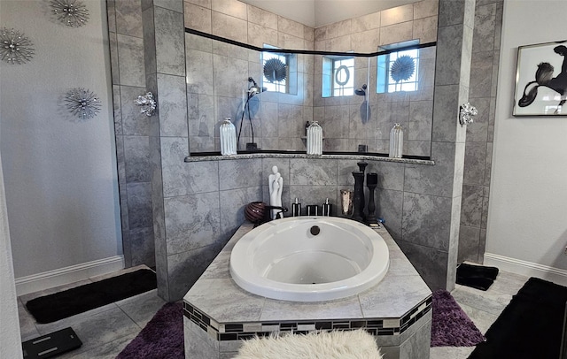 bathroom with independent shower and bath and tile patterned floors