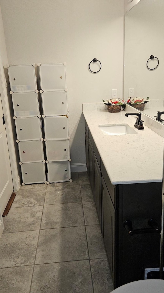 bathroom with tile patterned floors and vanity