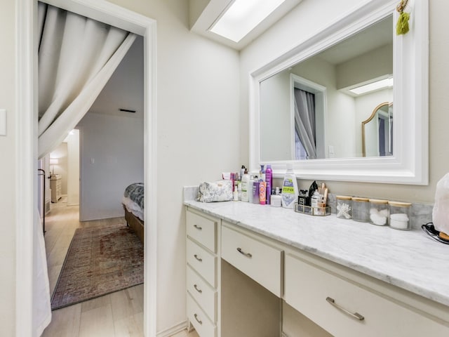 bathroom featuring hardwood / wood-style floors and vanity