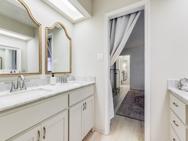 bathroom with hardwood / wood-style flooring and vanity