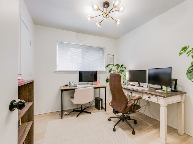 office with light hardwood / wood-style floors and a chandelier