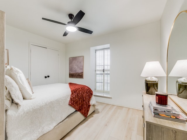 bedroom featuring ceiling fan, a closet, and light hardwood / wood-style floors