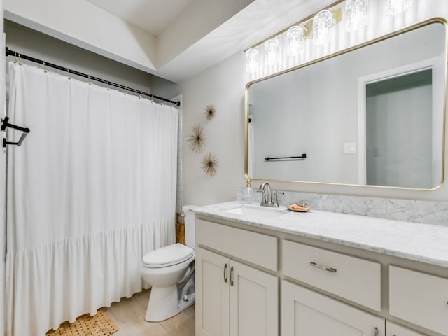 full bathroom with vanity, shower / bath combination with curtain, and toilet