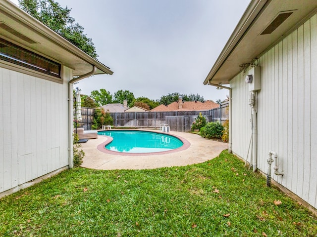 view of swimming pool featuring a yard and a patio