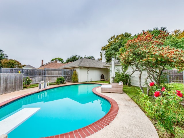 view of pool featuring a diving board