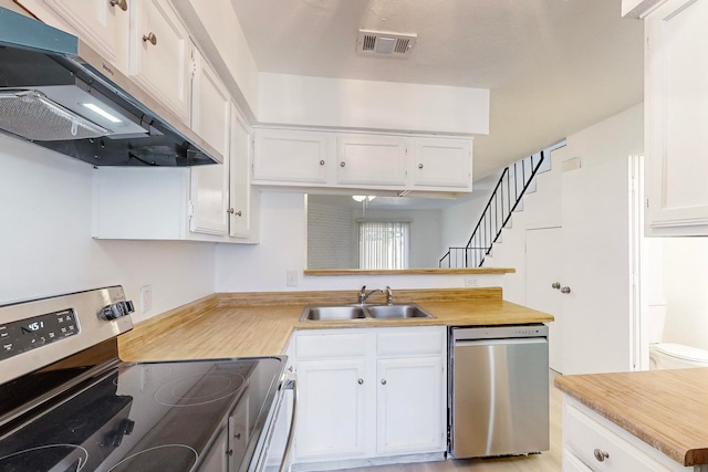 kitchen with white cabinets, sink, light wood-type flooring, and stainless steel appliances