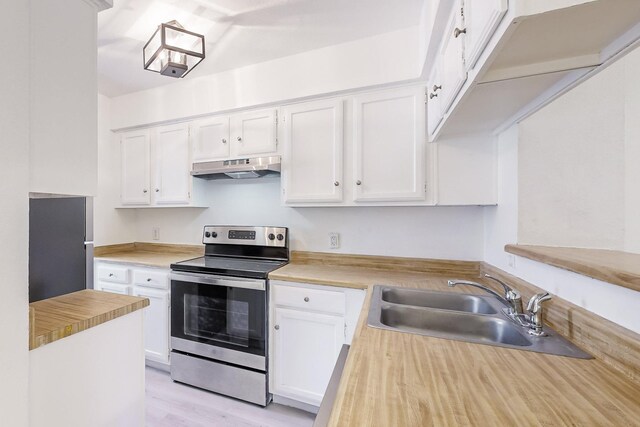 kitchen with white cabinetry, sink, stainless steel appliances, and light wood-type flooring